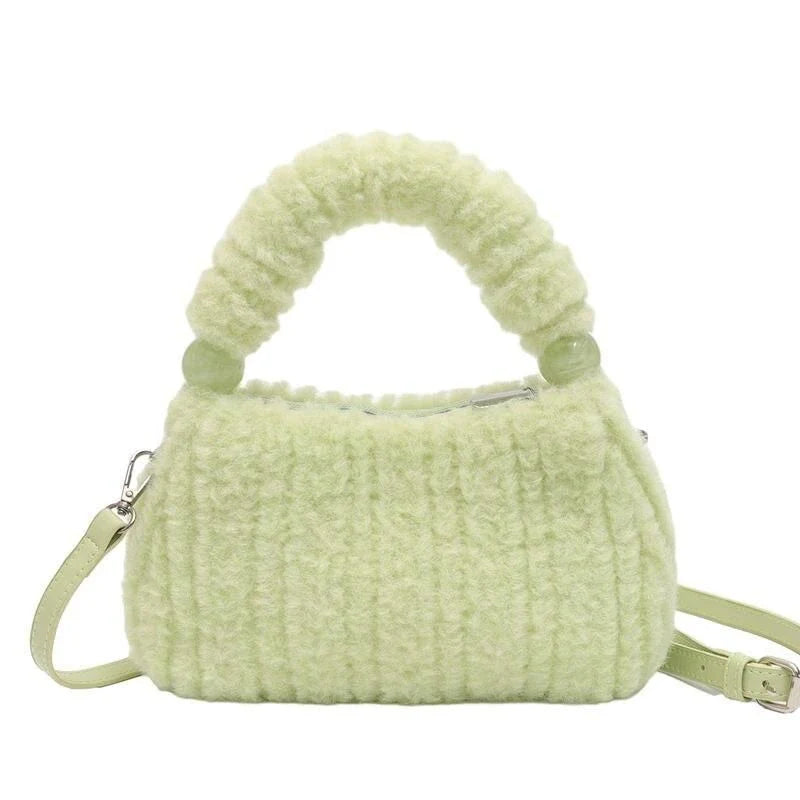 A luxurious faux fur hobo handbag with a stylish baguette shape and secure zipper closure