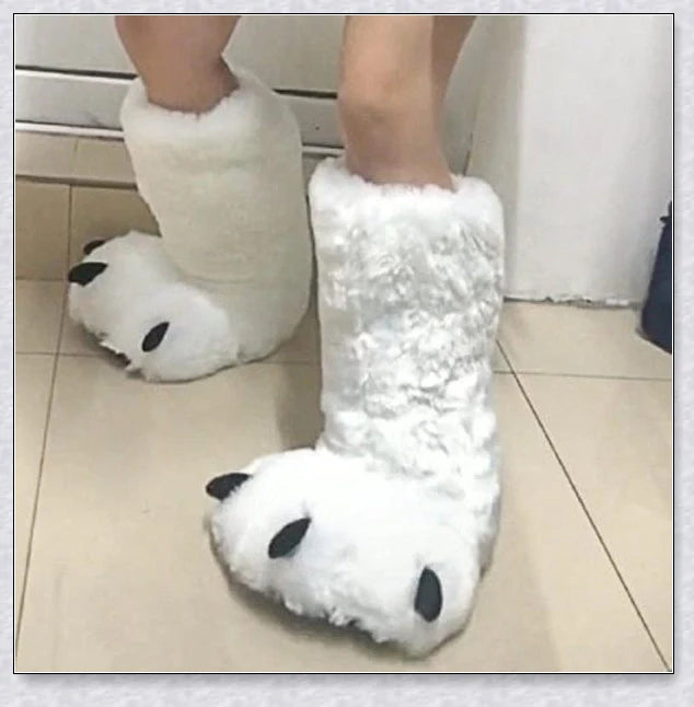 Cosy and whimsical oversized bear paw winter slippers with a plush, fluffy design and non-slip sole for secure indoor wear