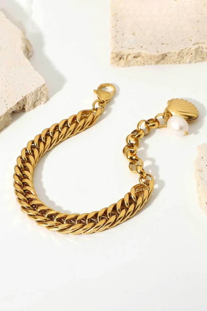 Elegant 18-carat gold-plated curb chain bracelet with a delicate pearl accent, showcasing premium British craftsmanship