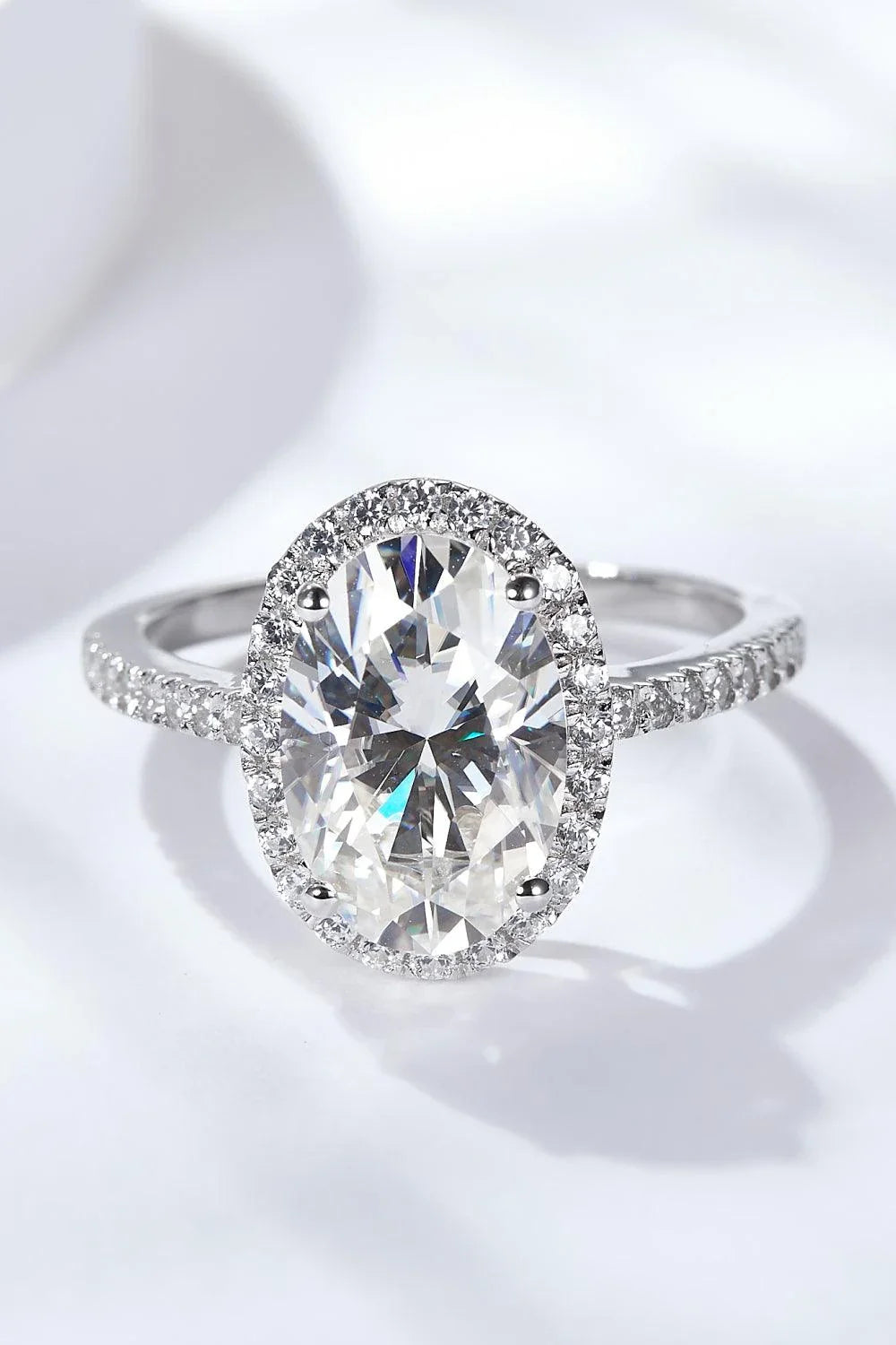 Elegant 4.5 carat moissanite halo ring in sterling silver with platinum plating, showcasing a captivating centre stone and delicate gem-studded design
