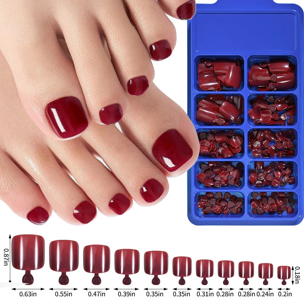 Elegant short square press-on toenails in vibrant pink, red, and nude shades for a polished and convenient pedicure