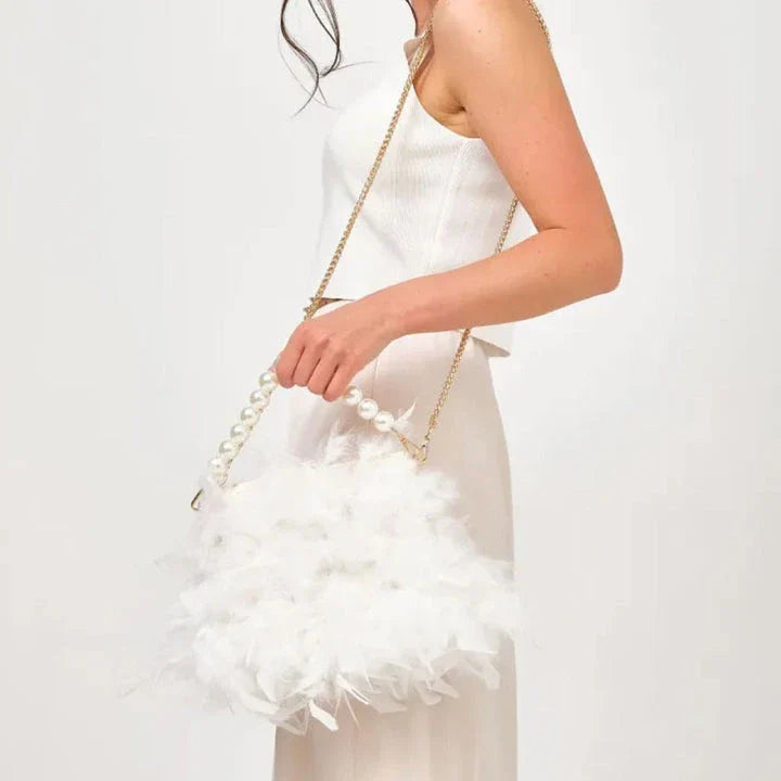 Elegant feather clutch purse with lustrous pearls, metal chains, and a top handle design