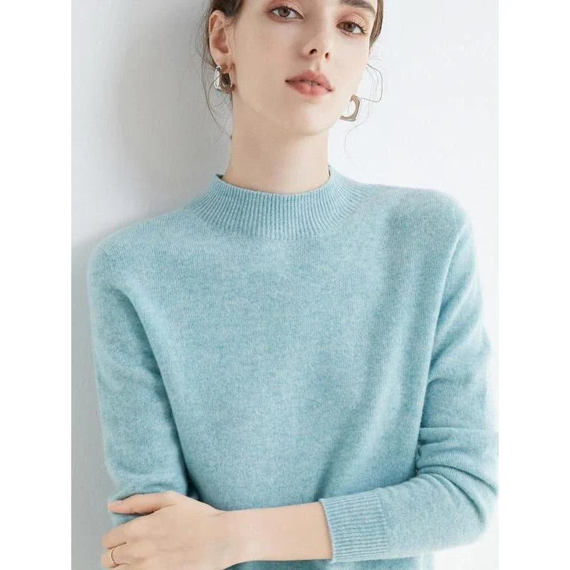 A woman wearing a luxurious Merino wool mock-neck jumper in a stylish autumnal outfit