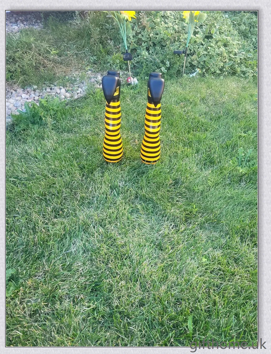 Animated witch legs in various colours, including purple, yellow, and black and white, kicking and moving to create a spooky Halloween display