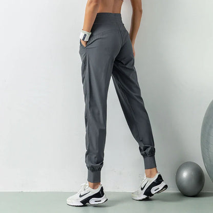 Premium women's sports trousers with drawstring waist and pockets, made of high-quality nylon fabric for comfort and versatility.