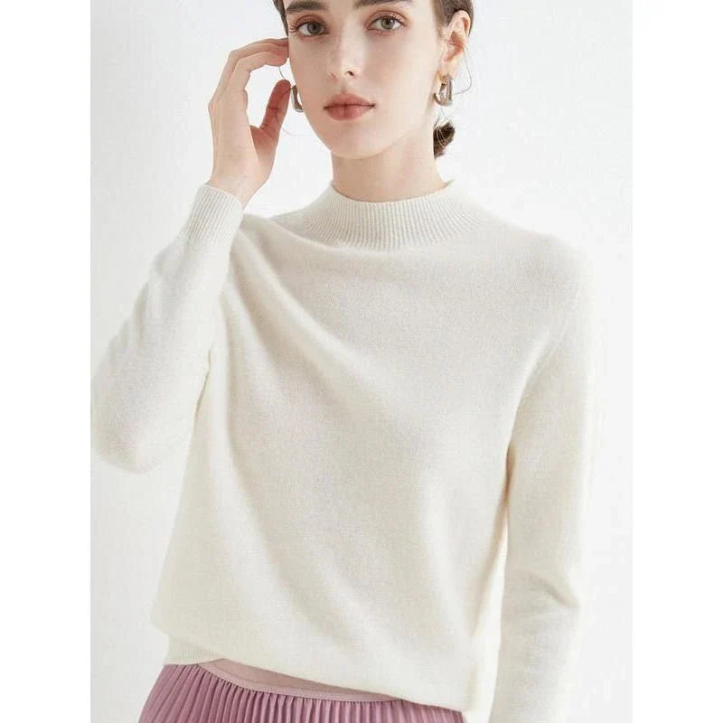 A woman wearing a luxurious Merino wool mock-neck jumper in a stylish autumnal outfit