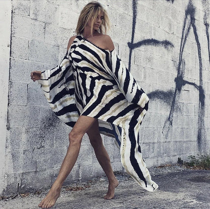 A chic inclined shoulder printed dress in a vibrant colour with a large, swinging skirt