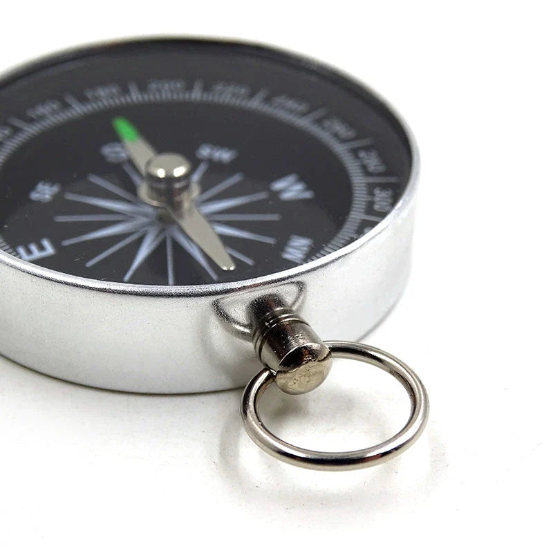 Compact aluminium compass keychain with tempered glass surface and bright compass face, perfect for outdoor adventures in the UK