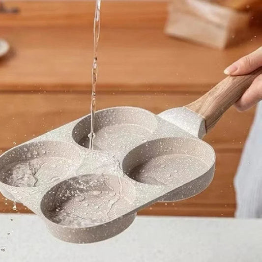 Premium non-stick frying pan with four-hole design for cooking eggs, burgers, and more - a versatile kitchen essential from a British brand
