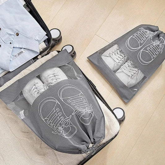 A set of grey travel shoe storage organiser bags with transparent panels for easy identification of contents