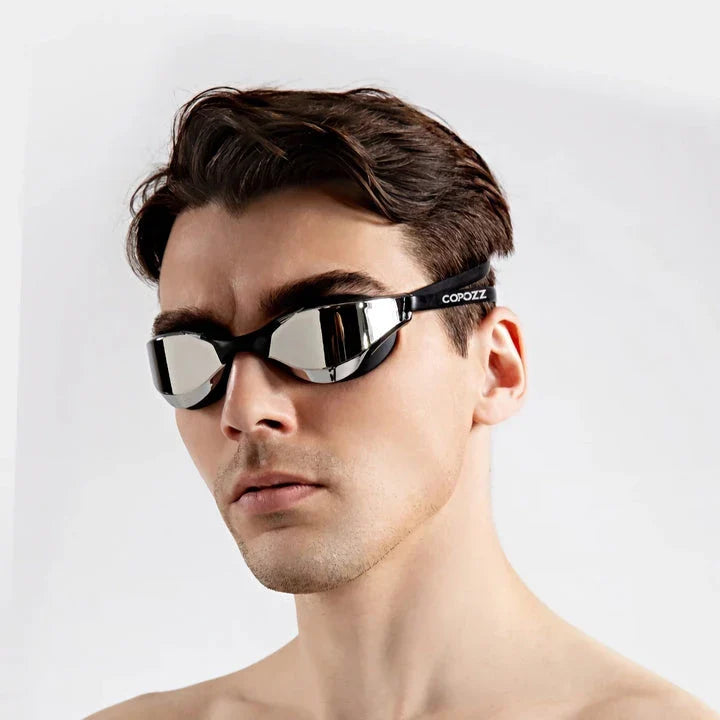 Premium British-made swimming goggles with anti-fog and UV protection technology, designed for clear visibility and comfort in pools, beaches, and water parks.