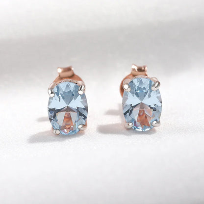 Geometrically simple sterling silver earrings in a rose gold finish, showcasing a minimalist and elegant design