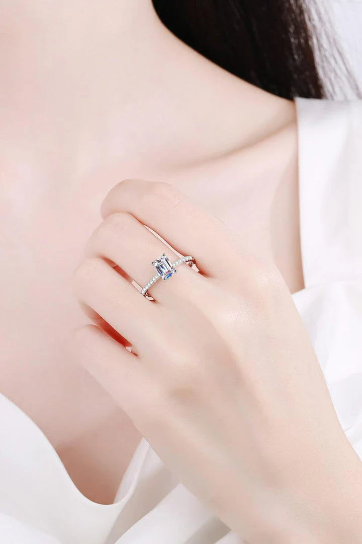 Exquisite 925 sterling silver ring with a radiant moissanite centre stone, accented with sparkling zircon stones for added elegance.
