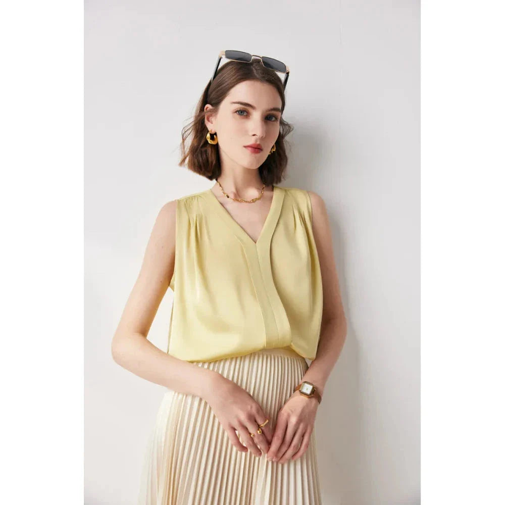 Elegant sleeveless silk blouse in a vibrant blue colour, designed for a sophisticated summer style