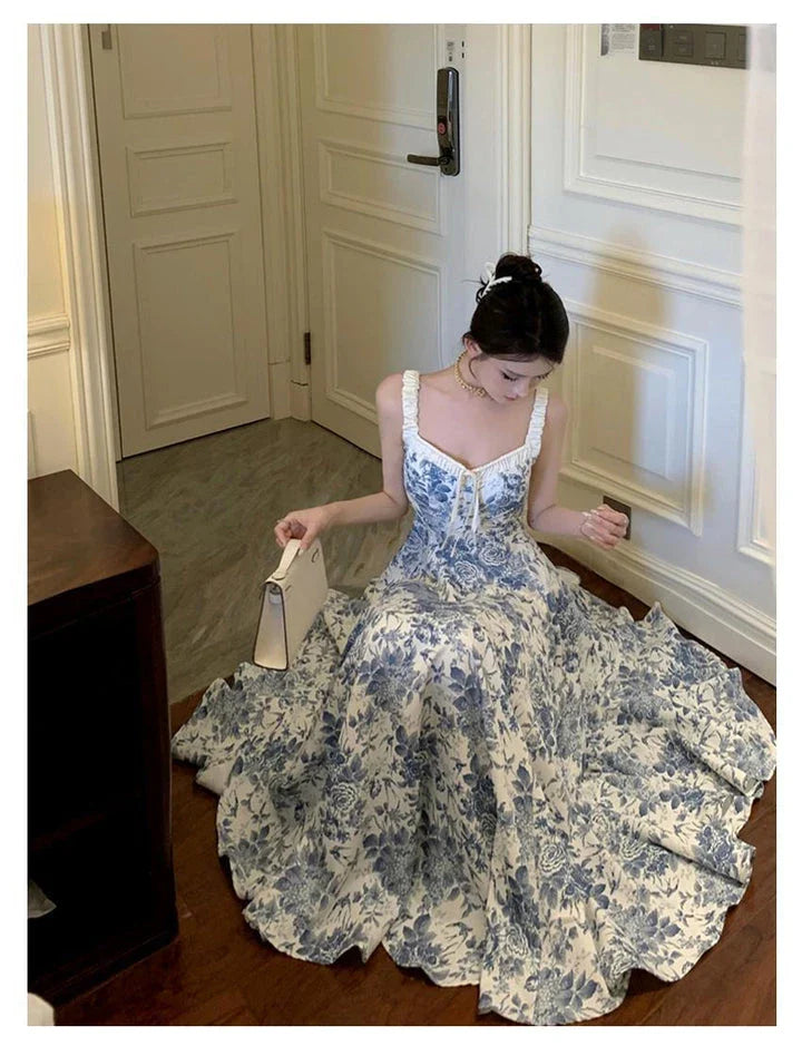 Elegant floral print dress with adjustable straps, A-line silhouette, and high-waisted design for a timeless British fashion look.