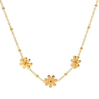 Exquisite 18-carat gold-plated necklace featuring three delicate daisy pendants on a stainless steel chain, embodying timeless British elegance and sophistication.