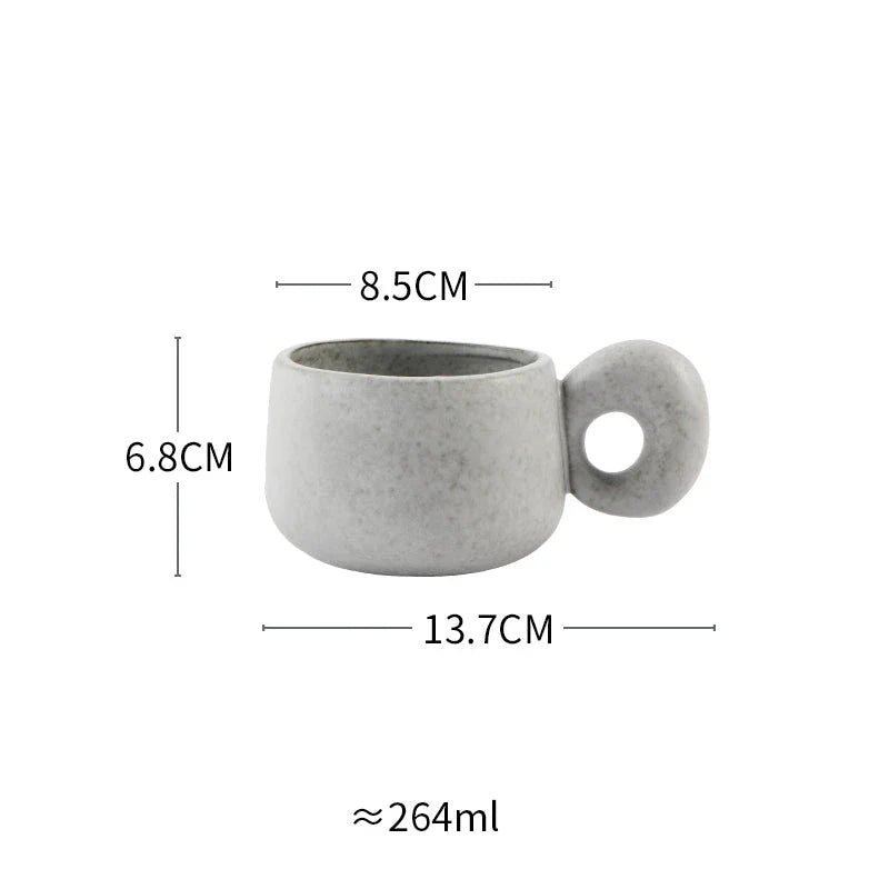 Handcrafted Japanese ceramic retro coffee mug in solid apricot or grey colour, featuring a comfortable handgrip design for enhanced daily beverage enjoyment.