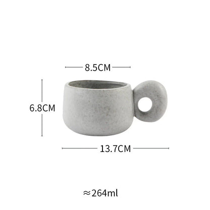 Handcrafted Japanese ceramic retro coffee mug in solid apricot or grey colour, featuring a comfortable handgrip design for enhanced daily beverage enjoyment.