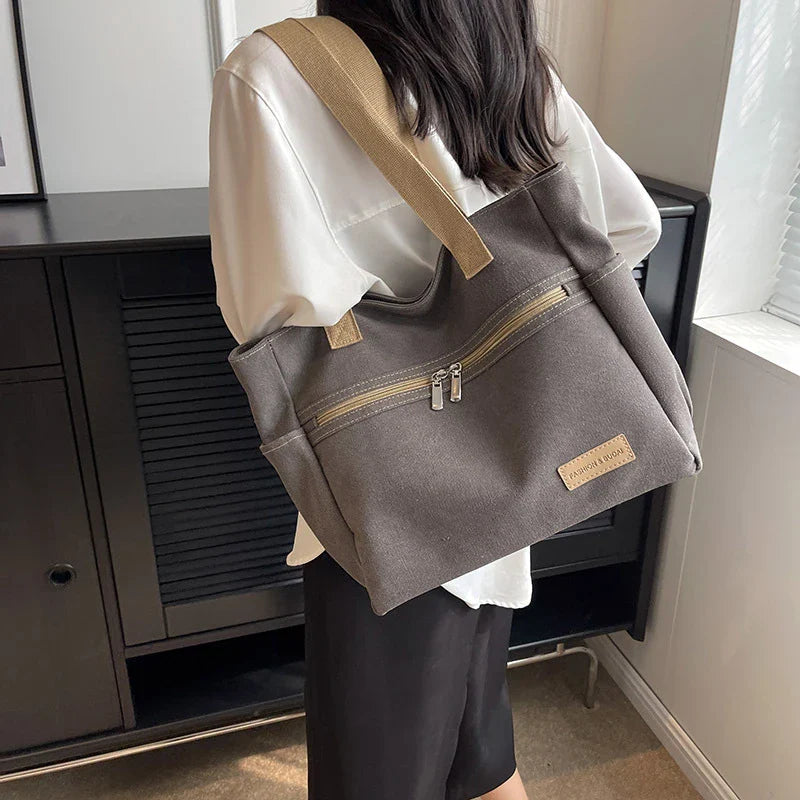 Premium canvas shoulder bag in grey, khaki, and green colours, featuring a stylish and functional design for everyday use.