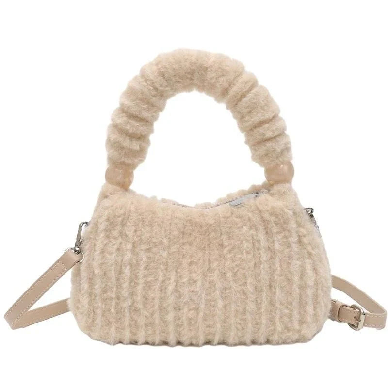 A luxurious faux fur hobo handbag with a stylish baguette shape and secure zipper closure