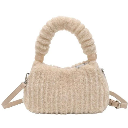 A luxurious faux fur hobo handbag with a stylish baguette shape and secure zipper closure