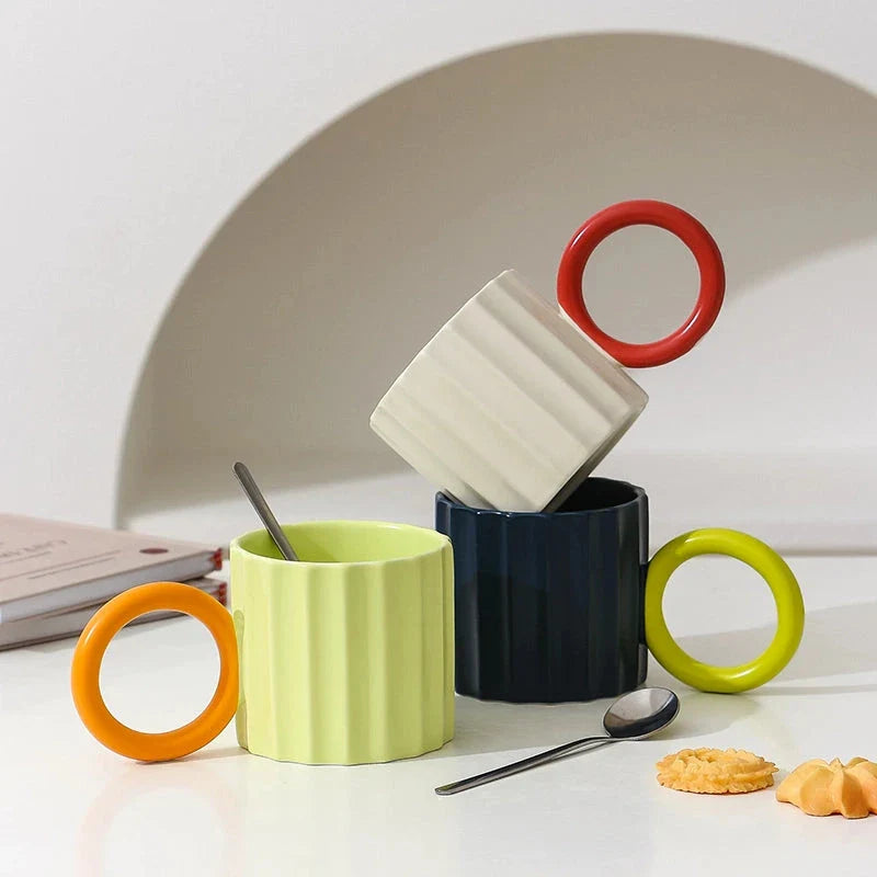 Japanese-style ceramic coffee mug with a unique ripple handle design, perfect for hot and cold beverages