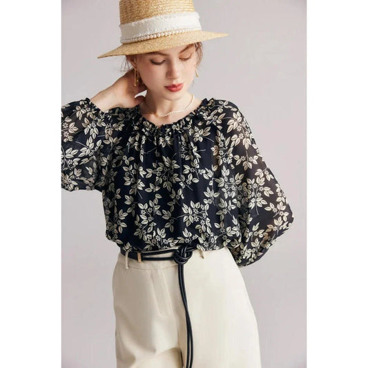 Floral silk blouse with ruffles and round neckline, showcasing the elegant and comfortable design for versatile wear.