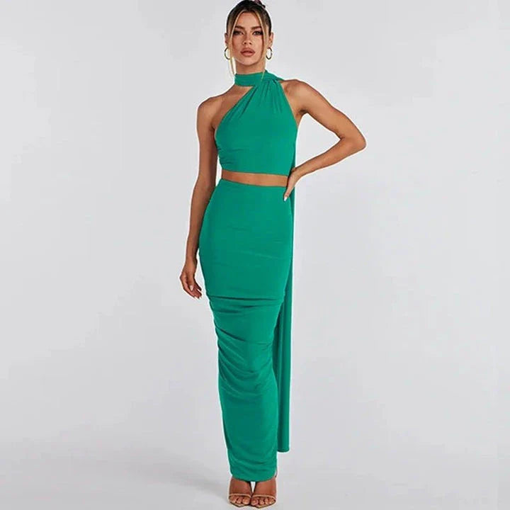 Glamorous backless cocktail dress set with halter-neck crop top and flowing maxi skirt in green colour