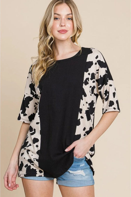 Stylish ribbed tee with playful cow print design, perfect for casual and smart-casual occasions.