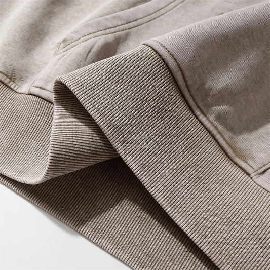 Embroidered cotton hoodie with a letter patch design, available in brown, grey, and black colours and sizes S to XL