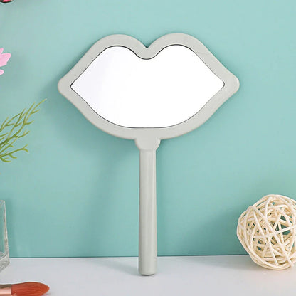 Lip-shaped handheld makeup mirror with a comfortable ergonomic handle for precise on-the-go touch-ups