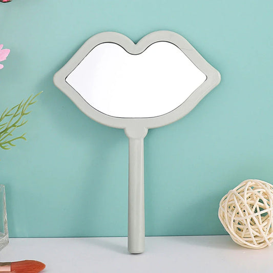 Lip-shaped handheld makeup mirror with a comfortable ergonomic handle for precise on-the-go touch-ups