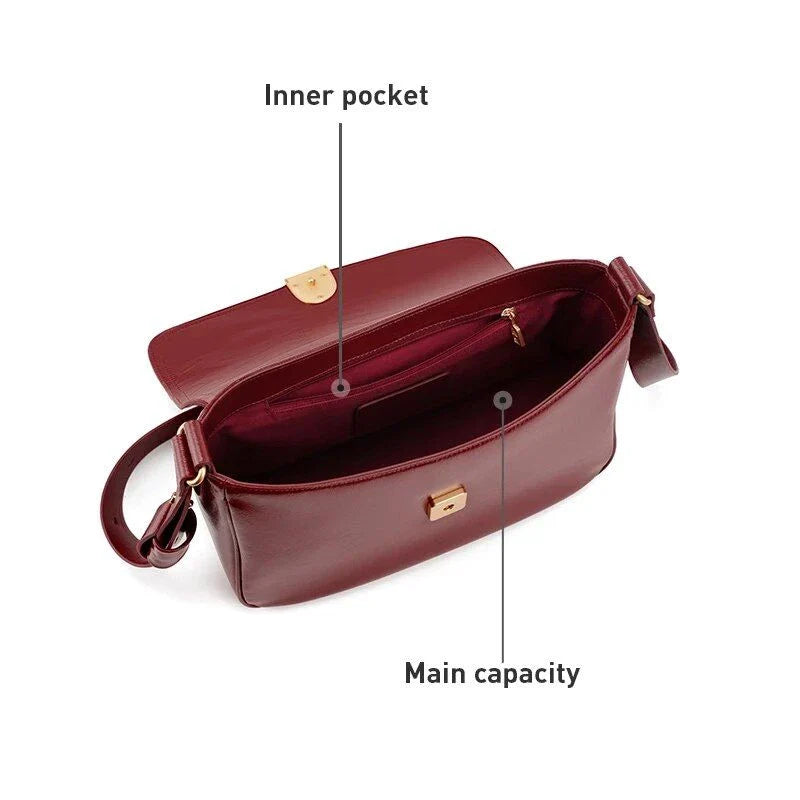 Stylish leather shoulder and crossbody bag in burgundy colour, with a square silhouette and sleek design