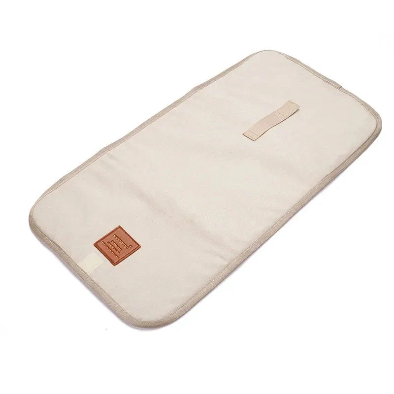Premium waterproof changing pad for babies, featuring a compact, foldable design and soft, skin-friendly materials for a comfortable, hygienic nappy changing experience on the go.