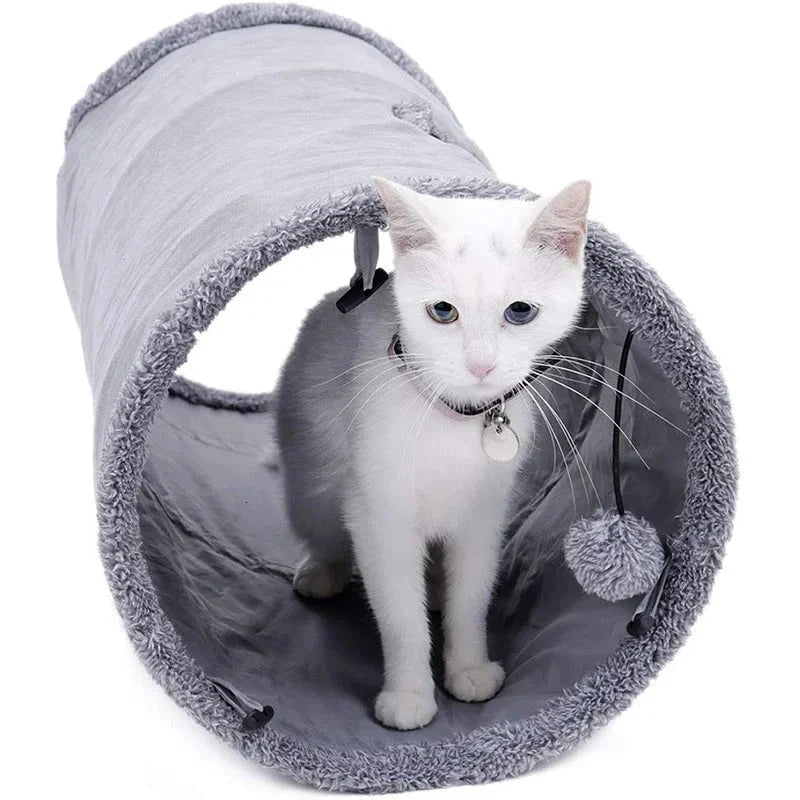A collapsible cat tunnel made of crinkle suede with a peek-a-boo hole and dangling ball, providing a stimulating and entertaining play experience for cats.