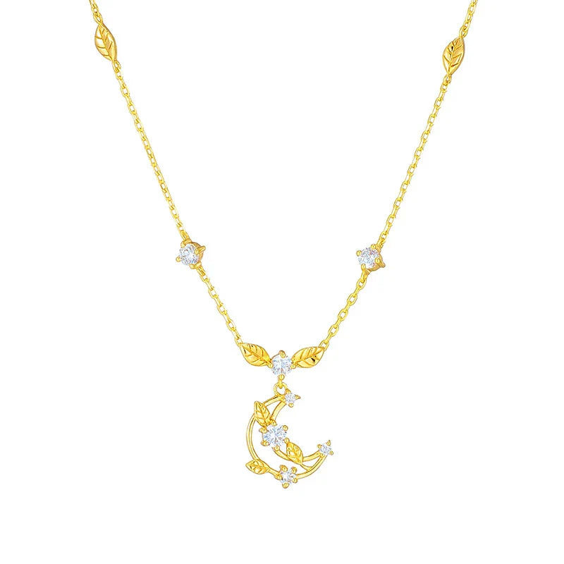 Elegant crescent moon necklace with intricate leaf design in a gleaming gold tone
