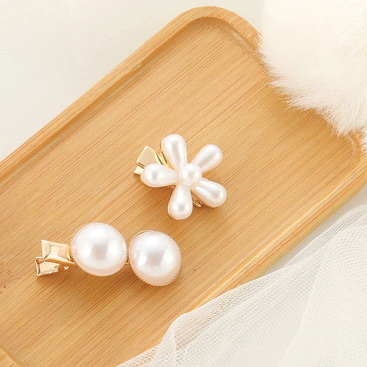 Elegant silver-toned hair clip with a beautiful pearl flower design, a timeless British-inspired accessory