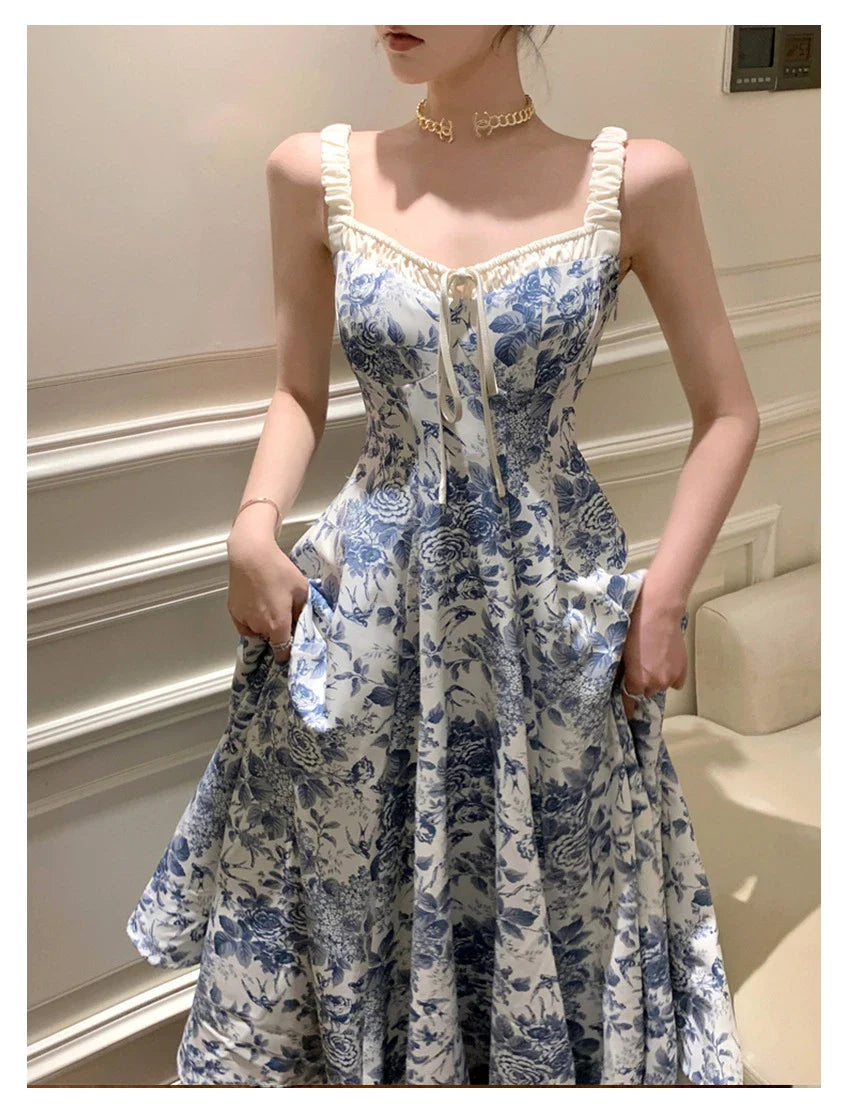 Elegant floral print dress with adjustable straps, A-line silhouette, and high-waisted design for a timeless British fashion look.