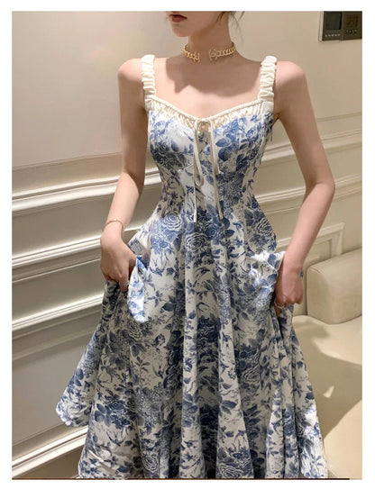 Elegant floral print dress with adjustable straps, A-line silhouette, and high-waisted design for a timeless British fashion look.