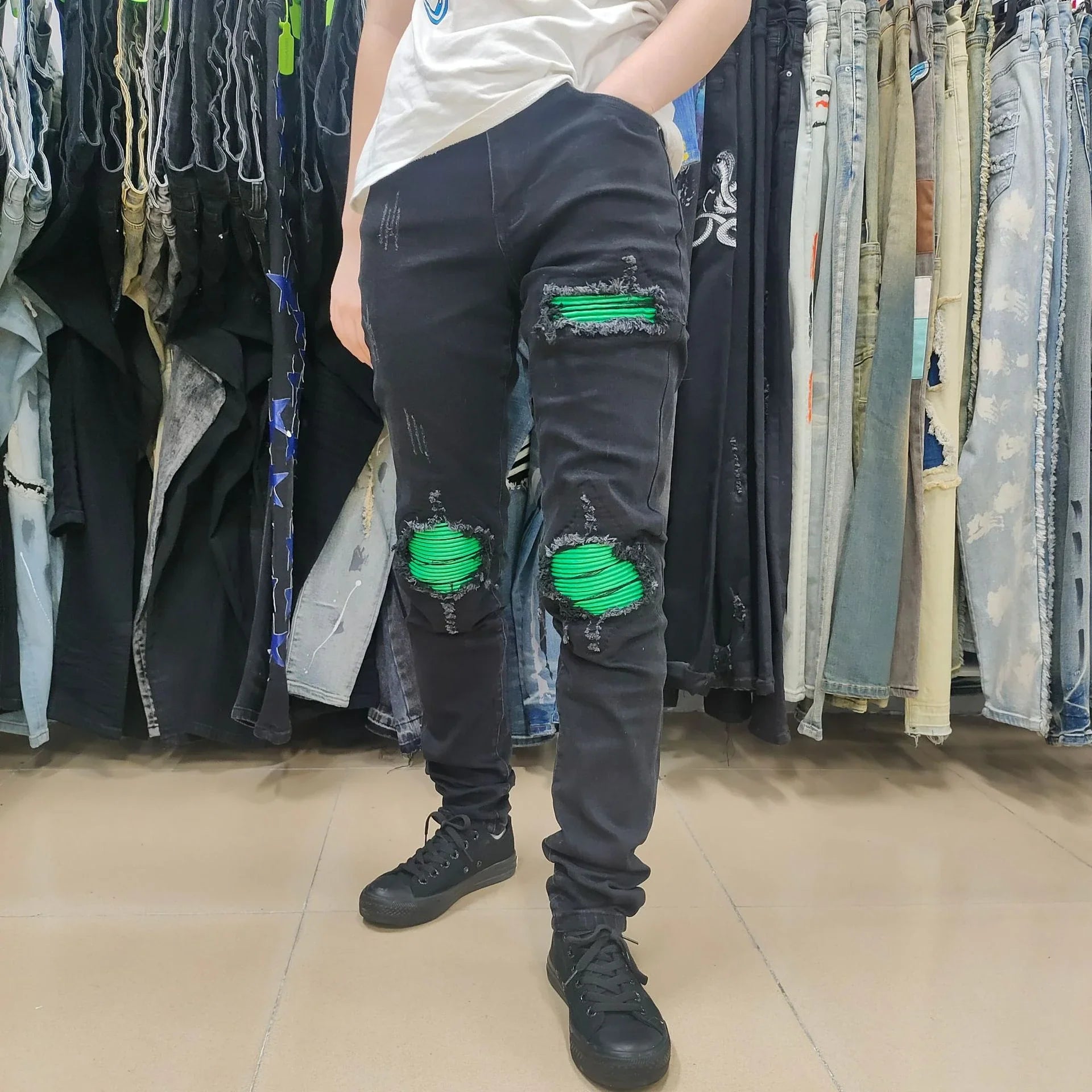 Premium ripped black jeans with stylish green patchwork design, made with medium-elastic fabric for comfort and a slim, flattering silhouette.