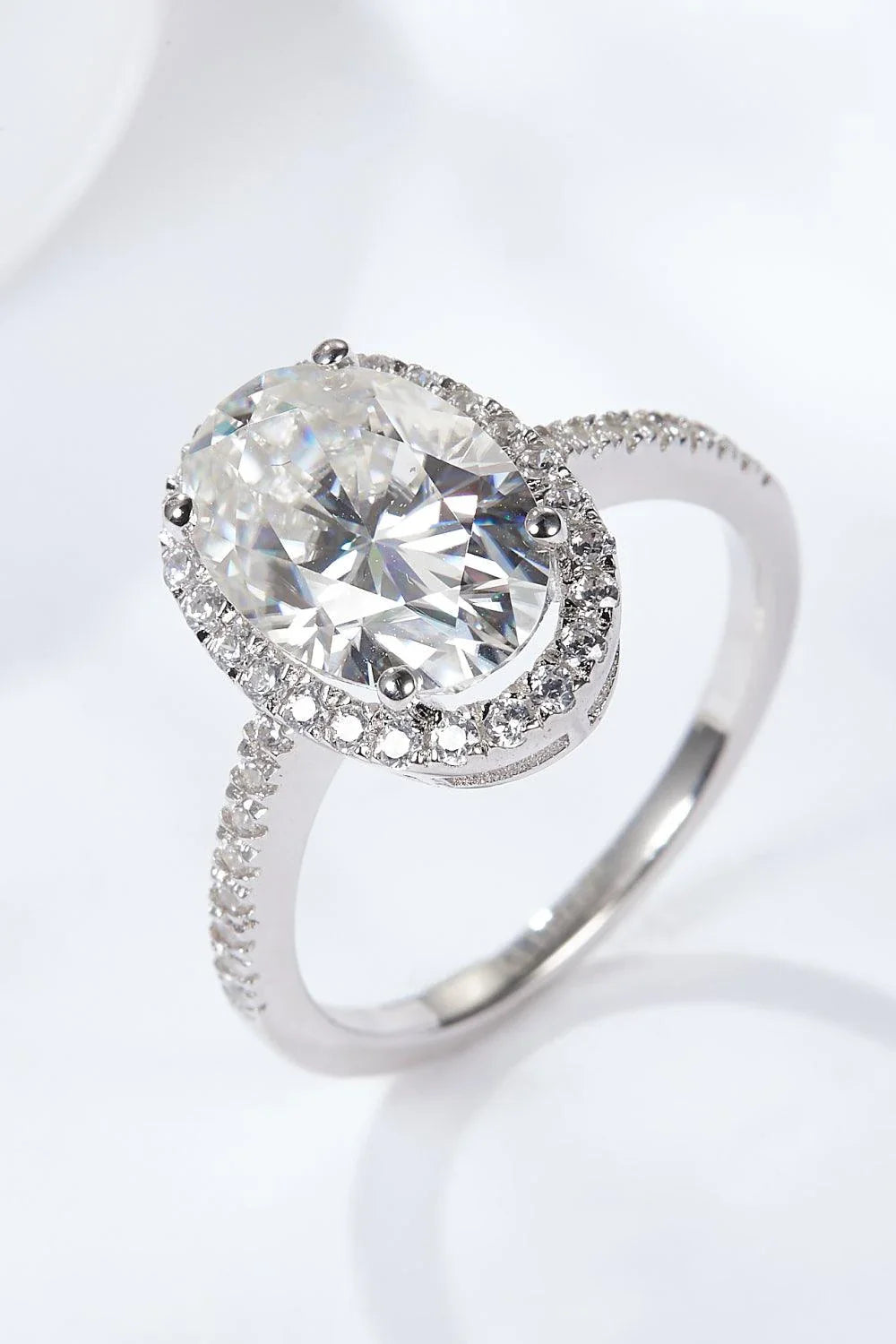 Elegant 4.5 carat moissanite halo ring in sterling silver with platinum plating, showcasing a captivating centre stone and delicate gem-studded design