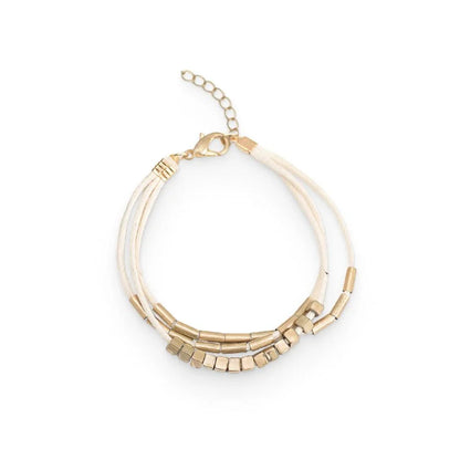 Stylish multilayered bracelet with beige leather ropes and gold-coloured beads, a modern and sophisticated accessory