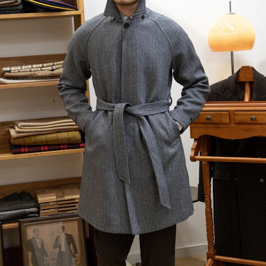 Premium mid-length herringbone wool coat in a sophisticated dark grey hue, featuring a tailored slim-fit silhouette for a refined, stylish appearance.
