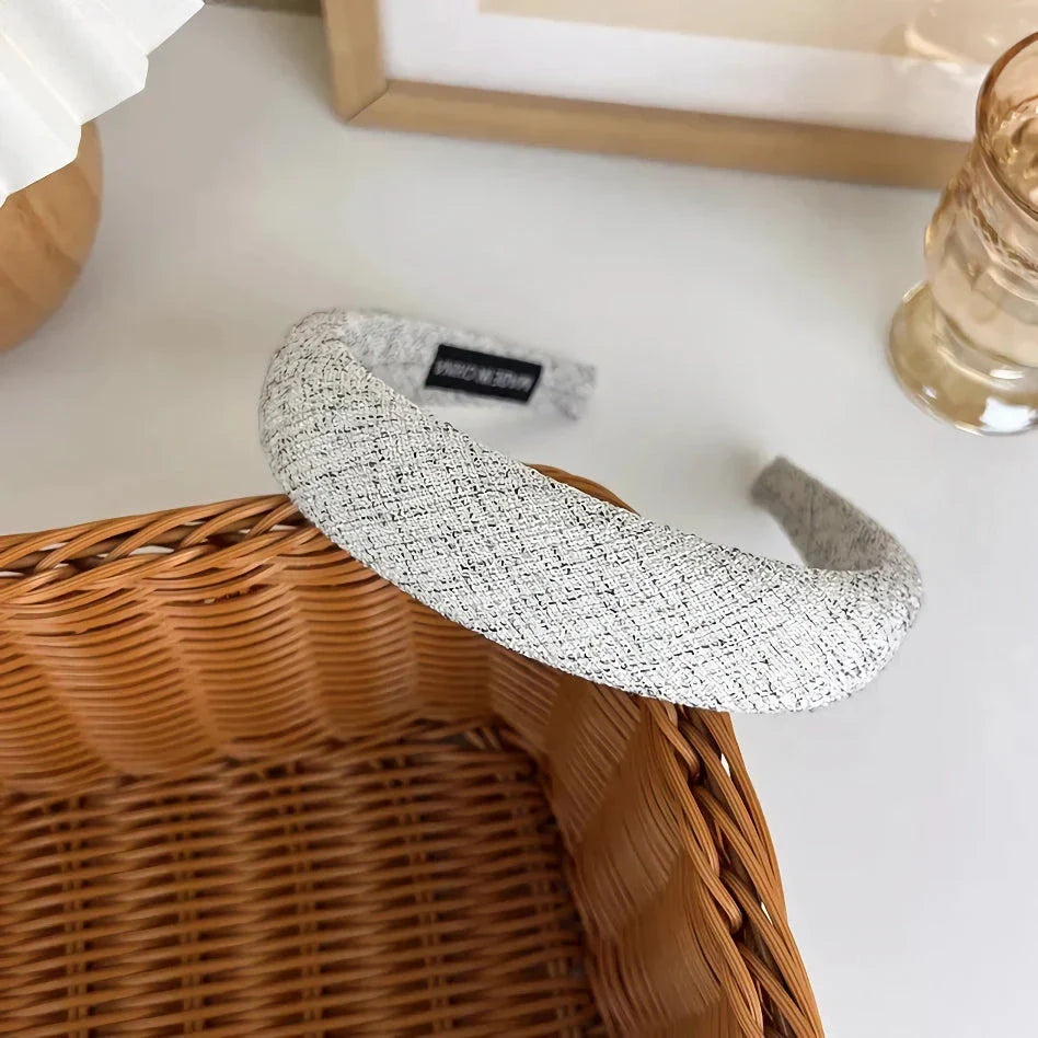 A stylish wide hairband in a classic plaid pattern, offering a chic and sophisticated look for British women.