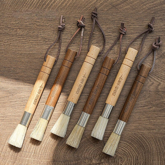 Premium espresso brush with natural fibre bristles and wooden handle, used to clean coffee grinders and equipment