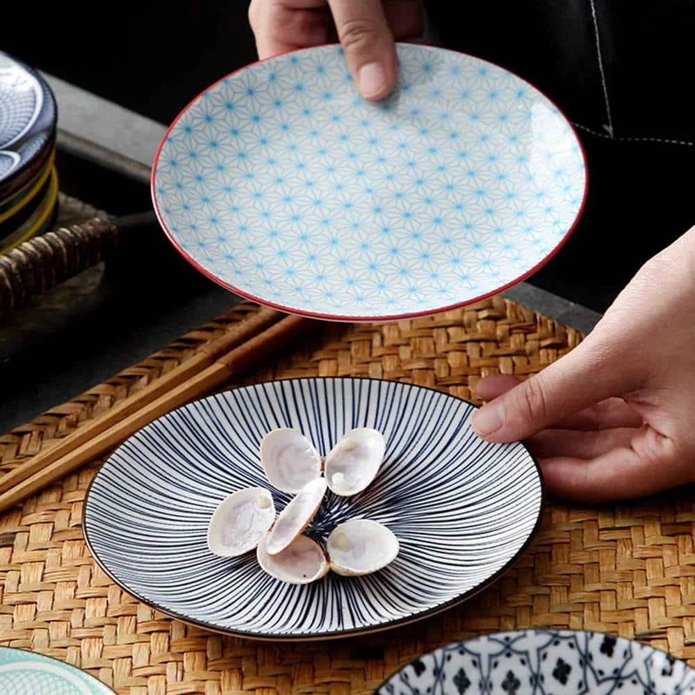 Elegant ceramic plates with vibrant, whimsical prints in a variety of enchanting designs