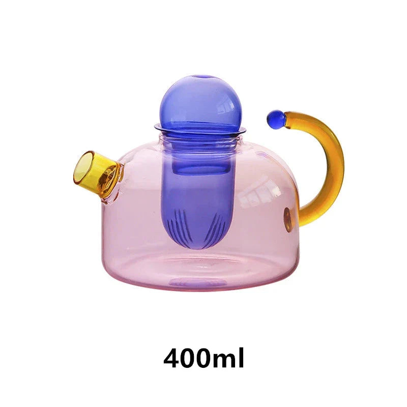 Elegant colourful glass teapot and teacup set with vibrant contrasting colours, perfect for tea and coffee enjoyment