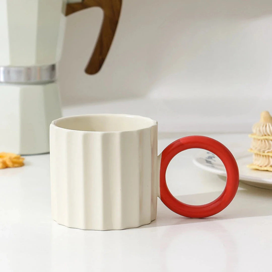 Japanese-style ceramic coffee mug with a unique ripple handle design, perfect for hot and cold beverages