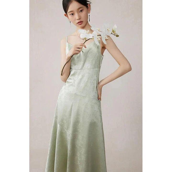Elegant mint green midi dress with spaghetti straps, featuring a flattering slim fit and beautiful embroidery detailing