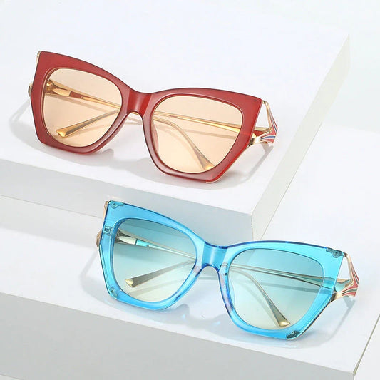 Refined cat eye sunglasses with blue gradient lenses and sleek metal frames, offering timeless British style and UV400 protection.